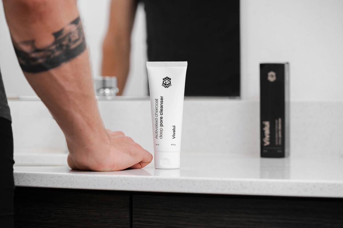 Woman applying firming cream for cellulite on thighs with upward massage motion