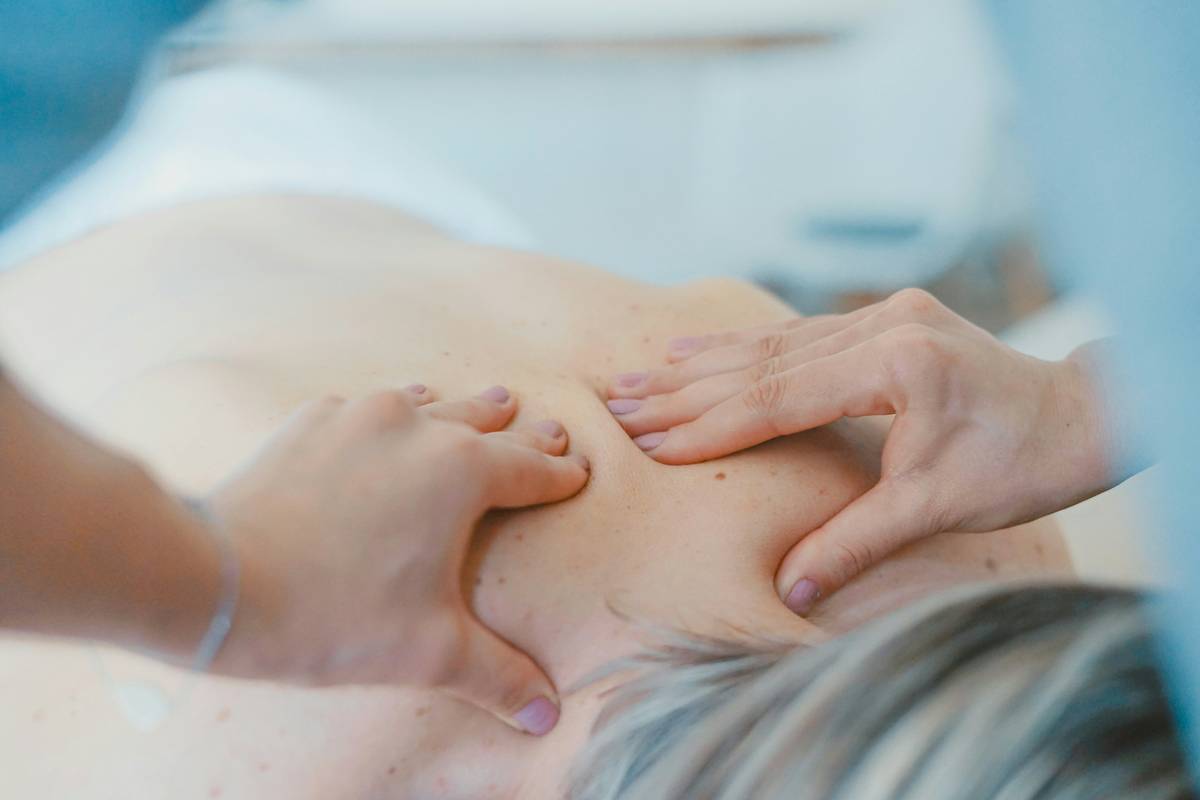 Woman applying dim cream for cellulite to her thigh with gentle circular motions