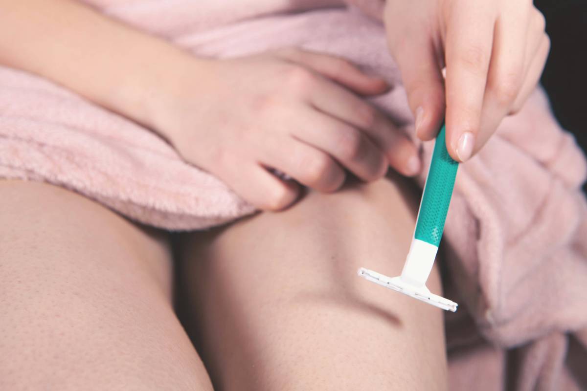 Woman applying cellulite treatment cream to thighs while checking mirror, illustrating usage expectation cellulite treatment cream do